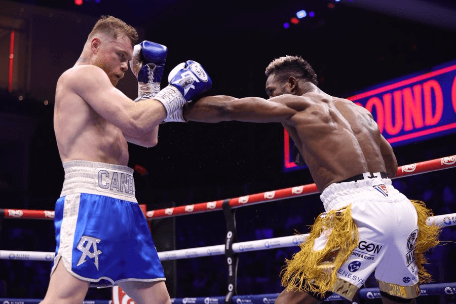 Professional boxing match with boxers in blue and white shorts